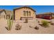Single-story home showcasing desert landscaping, a stucco exterior, and a red disposal container at 464 W Bismark St, San Tan Valley, AZ 85143