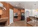 Kitchen featuring stainless steel appliances, granite countertops, tile flooring, and wood cabinets at 464 W Bismark St, San Tan Valley, AZ 85143