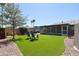 Spacious backyard features well-maintained artificial grass, patio and mature trees at 510 E Fremont Dr, Tempe, AZ 85282