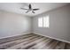 Bedroom featuring ceiling fan, window with shutters, and wood-look floors at 510 E Fremont Dr, Tempe, AZ 85282