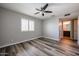 Bedroom featuring ceiling fan, window with shutters, and en-suite bathroom at 510 E Fremont Dr, Tempe, AZ 85282