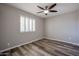 Neutral bedroom featuring wood-look floors, plantation shutters and ceiling fan at 510 E Fremont Dr, Tempe, AZ 85282
