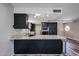 Modern kitchen with granite countertops, stainless steel appliances, and dark cabinets at 510 E Fremont Dr, Tempe, AZ 85282