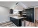 Open kitchen with granite countertops, stainless steel appliances, and wood floors at 510 E Fremont Dr, Tempe, AZ 85282