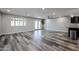 Well-lit living room featuring wood-look flooring, recessed lighting, and access to the backyard at 510 E Fremont Dr, Tempe, AZ 85282