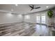 Bright living room with wood-look flooring, recessed lights, and access to the outdoor area at 510 E Fremont Dr, Tempe, AZ 85282