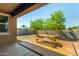 Inviting backyard patio with a wooden picnic table, perfect for outdoor dining and relaxation at 5218 W Lydia Ln, Laveen, AZ 85339