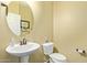 Cozy half bath features a pedestal sink, toilet, and decorative touches at 5218 W Lydia Ln, Laveen, AZ 85339