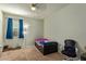 A clean bedroom with carpeted floors, a ceiling fan, and natural light at 5218 W Lydia Ln, Laveen, AZ 85339