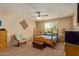 A comfortably furnished bedroom features soft carpet and an eye-catching ceiling fan at 5218 W Lydia Ln, Laveen, AZ 85339