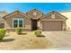 Charming single-story home featuring a well-maintained front yard and a two-car garage with a brick-paved driveway at 5218 W Lydia Ln, Laveen, AZ 85339
