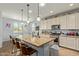 Spacious kitchen featuring a large island with bar seating, granite countertops, stainless steel appliances, and pendant lights at 5218 W Lydia Ln, Laveen, AZ 85339