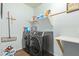 Convenient laundry room equipped with modern, front-load washer and dryer set at 5218 W Lydia Ln, Laveen, AZ 85339