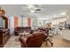 Inviting living room featuring comfortable leather seating, neutral walls, wood-look floors, and open access to kitchen at 5218 W Lydia Ln, Laveen, AZ 85339