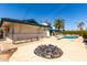 Expansive backyard with a diving board near the pool and a unique fire pit for outdoor gatherings at 537 N Jay St, Chandler, AZ 85225