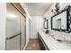 Well-lit bathroom showcasing a glass shower, dual sinks and stylish vanity mirrors at 537 N Jay St, Chandler, AZ 85225
