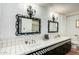 Classic bathroom featuring dual sinks, decorative mirrors and detailed tile work throughout at 537 N Jay St, Chandler, AZ 85225
