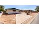 Spacious driveway leading to a charming home with unique architectural details and desert landscaping at 537 N Jay St, Chandler, AZ 85225