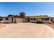 Wide shot of a ranch-style home with a circular driveway, desert landscaping, and an attached garage at 537 N Jay St, Chandler, AZ 85225