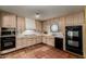 Traditional kitchen with tile floors, wooden cabinets, and modern appliances at 537 N Jay St, Chandler, AZ 85225