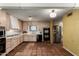 Bright kitchen with tile floors, wood cabinets, and stainless steel refrigerator at 537 N Jay St, Chandler, AZ 85225