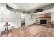 Cozy living room featuring a brick fireplace, tiled floors, and built-in shelving at 537 N Jay St, Chandler, AZ 85225