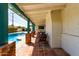 Covered patio featuring brick columns and tiled flooring, overlooking the pool and backyard at 537 N Jay St, Chandler, AZ 85225