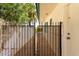 Side yard with a wrought iron gate, cream colored walls, and green trim on the home at 537 N Jay St, Chandler, AZ 85225