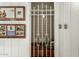 Wine cellar protected by a metal gate, framed by framed wall art at 537 N Jay St, Chandler, AZ 85225