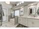 Bright bathroom features double sink vanity, bathtub, and recessed lighting at 5674 W North Ln, Glendale, AZ 85302