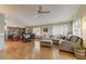 Open-concept living area featuring a large sectional sofa, hardwood floors and lots of natural light at 5674 W North Ln, Glendale, AZ 85302