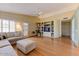 This spacious living room features an entertainment center, modern ceiling fan, hardwood floors and tons of natural light at 5674 W North Ln, Glendale, AZ 85302