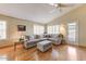 Bright and airy living room featuring a ceiling fan, hardwood floors and neutral color scheme at 5674 W North Ln, Glendale, AZ 85302