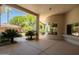 Spacious covered back patio with lush landscaping and views of the pool area at 6243 E Camelback Rd, Scottsdale, AZ 85251