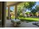 Back patio with outdoor seating overlooking a lush backyard at 6243 E Camelback Rd, Scottsdale, AZ 85251