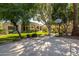 Large backyard featuring artificial turf, basketball court, and mature trees at 6243 E Camelback Rd, Scottsdale, AZ 85251