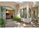 Inviting entrance featuring an arched doorway leading to the dining room at 6243 E Camelback Rd, Scottsdale, AZ 85251