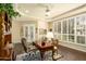 A home office features hardwood floors, built-in shelves and cabinets, a large desk, and French doors at 6243 E Camelback Rd, Scottsdale, AZ 85251