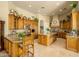 Gourmet kitchen featuring custom cabinets, granite counters, and a center island at 6243 E Camelback Rd, Scottsdale, AZ 85251