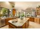 Open kitchen with a large center island, stainless steel appliances, and a sink at 6243 E Camelback Rd, Scottsdale, AZ 85251