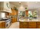 Spacious kitchen with stainless steel appliances, a large island, and ample storage space at 6243 E Camelback Rd, Scottsdale, AZ 85251