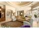 Spacious living room featuring neutral tones, ceiling fan and a seamless flow into the kitchen area at 6243 E Camelback Rd, Scottsdale, AZ 85251