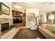 Comfortable living room with fireplace, built-in shelving and luxurious rug at 6243 E Camelback Rd, Scottsdale, AZ 85251