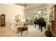 Sophisticated living room featuring a grand piano and views of the outdoor pool area at 6243 E Camelback Rd, Scottsdale, AZ 85251