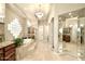 Bright main bathroom with a large soaking tub and dual sinks and mirrored wall at 6243 E Camelback Rd, Scottsdale, AZ 85251