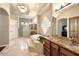 Luxurious main bathroom with a large soaking tub, granite counters, and stylish fixtures at 6243 E Camelback Rd, Scottsdale, AZ 85251