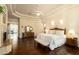 Large main bedroom featuring hardwood floors, ceiling fan, tray ceiling and ensuite bathroom at 6243 E Camelback Rd, Scottsdale, AZ 85251