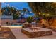 Resort-style backyard with fire pit, barbecue area, swimming pool, and lounge chairs at 700 N Dobson Rd # 54, Chandler, AZ 85224