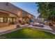 This outdoor space offers a covered patio, ambient lighting, a fire pit, and a swimming pool at 700 N Dobson Rd # 54, Chandler, AZ 85224