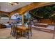 Outdoor living features a covered patio, dining table, fire pit, and a view of the refreshing pool at 700 N Dobson Rd # 54, Chandler, AZ 85224